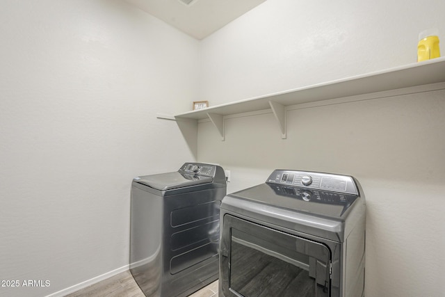 9934 E Orange Grove St, Florence, AZ 85132 - laundry room featuring separate washer and dryer and light wood-style flooring