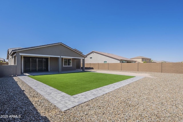 9934 E Orange Grove St, Florence, AZ 85132 - back of house featuring a fenced backyard, a patio area, and stucco siding