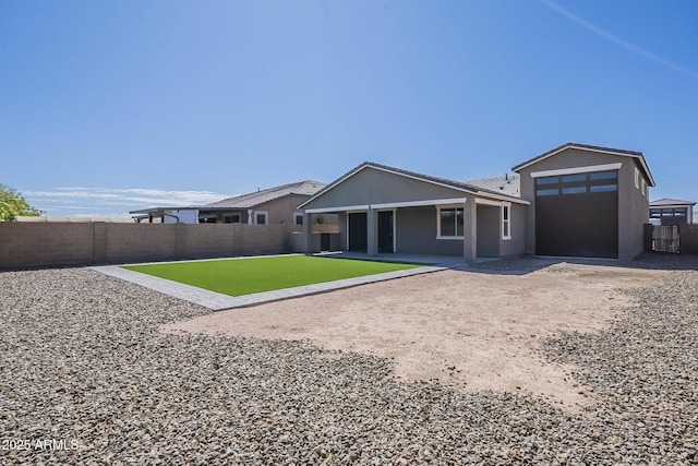 9934 E Orange Grove St, Florence, AZ 85132 - rear view of property featuring a fenced backyard, driveway, and stucco siding