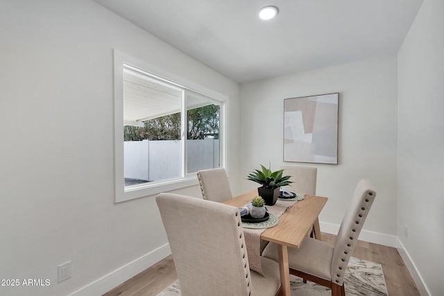 dining room with light wood-style flooring and baseboards