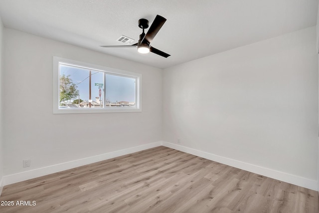 unfurnished room featuring light wood-style floors, a textured ceiling, baseboards, and a ceiling fan