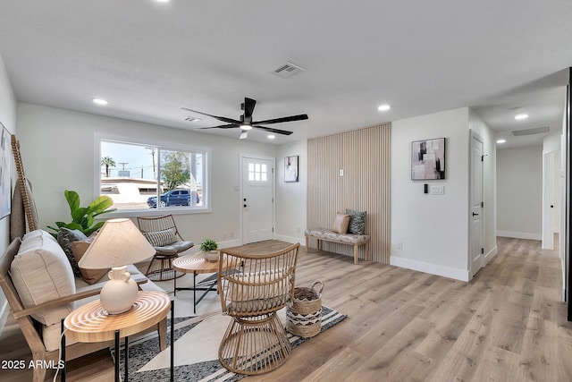 living area featuring recessed lighting, a ceiling fan, baseboards, visible vents, and light wood-style floors