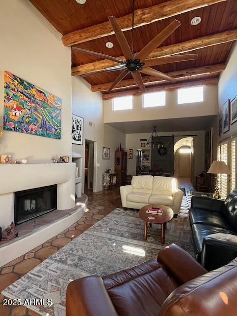 living room with wood ceiling, tile patterned floors, high vaulted ceiling, and beamed ceiling