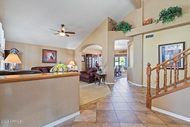 interior space featuring ceiling fan and high vaulted ceiling