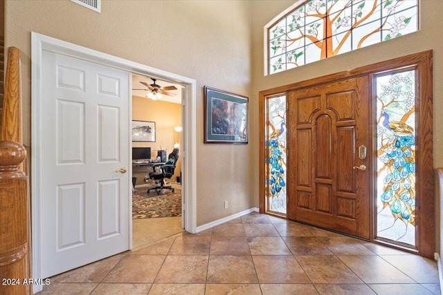 tiled entrance foyer with ceiling fan