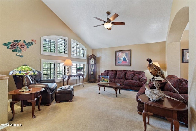 carpeted living room featuring ceiling fan and high vaulted ceiling