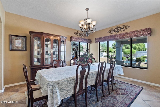 dining space with light tile patterned floors and a notable chandelier