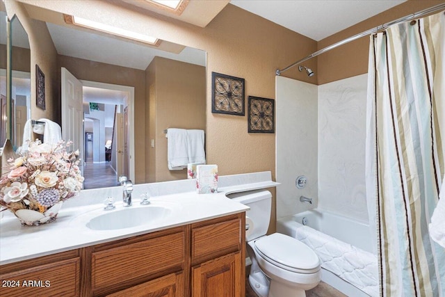 full bathroom featuring vanity, toilet, shower / bath combo, and a skylight