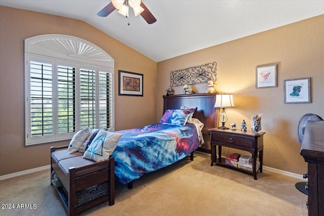 carpeted bedroom with vaulted ceiling and ceiling fan