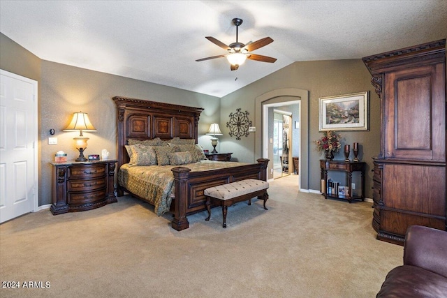 bedroom with ceiling fan, light colored carpet, and lofted ceiling