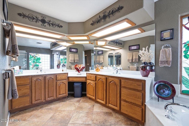 bathroom with a tub to relax in and vanity