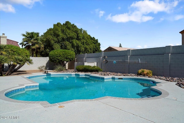 view of swimming pool featuring a diving board