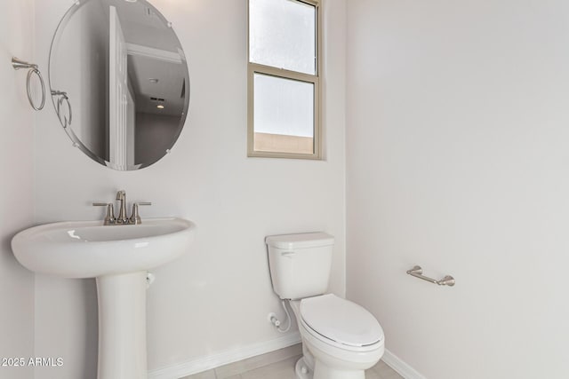 bathroom featuring tile patterned flooring and toilet