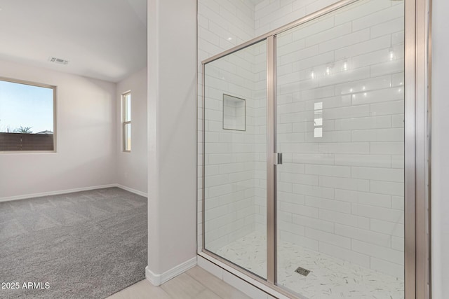 bathroom with a shower with shower door