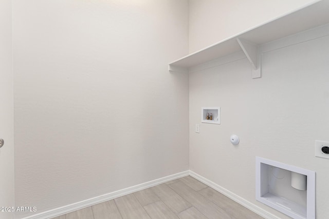 laundry area featuring hookup for an electric dryer, hookup for a washing machine, light hardwood / wood-style flooring, and gas dryer hookup