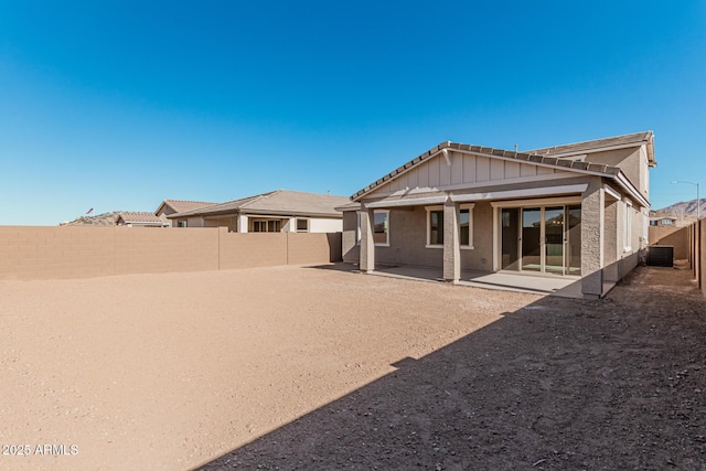 rear view of house with a patio area and central AC unit