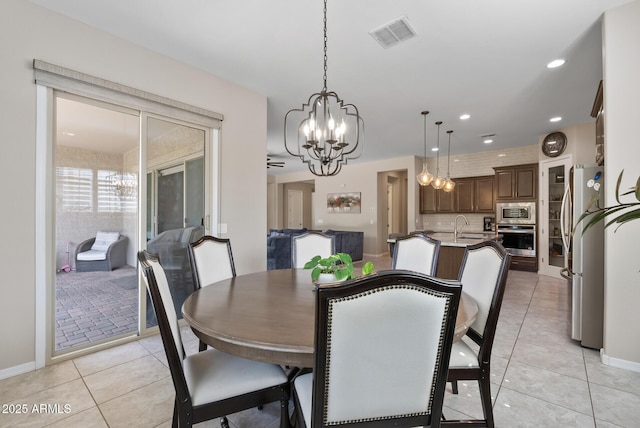 dining space with light tile patterned flooring, a chandelier, recessed lighting, and visible vents