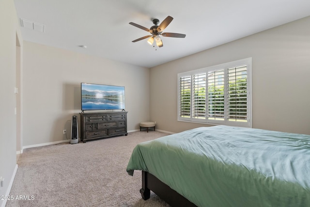 carpeted bedroom with baseboards, a ceiling fan, and visible vents