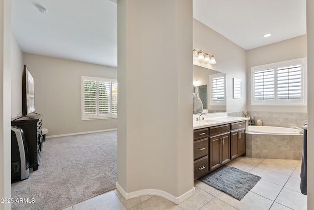 full bathroom featuring vanity, baseboards, a garden tub, and tile patterned floors