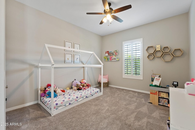 carpeted bedroom with baseboards and a ceiling fan