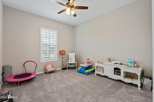 game room with carpet flooring, ceiling fan, and baseboards