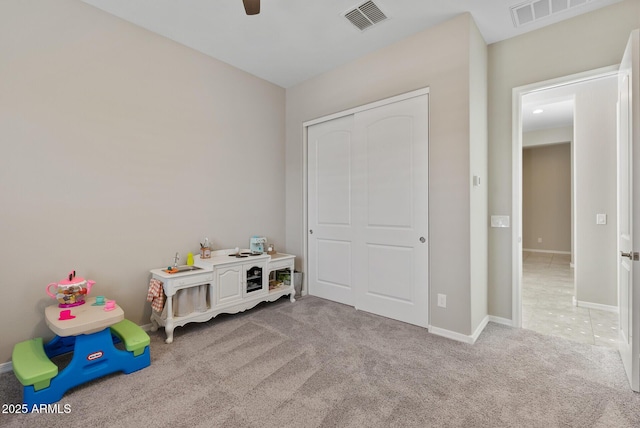rec room with ceiling fan, visible vents, baseboards, and carpet