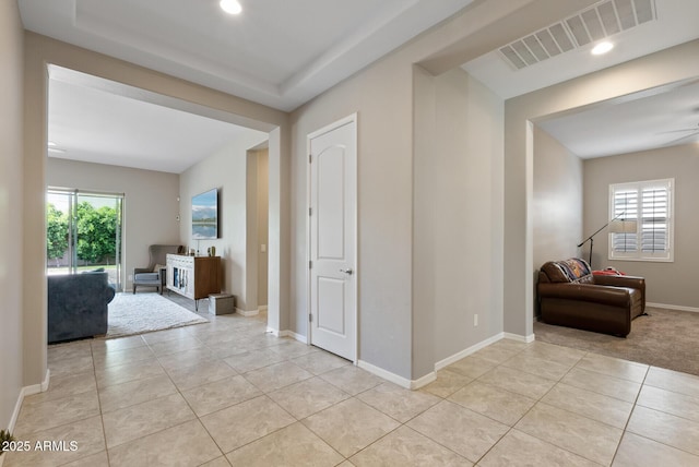 corridor featuring light tile patterned flooring, baseboards, visible vents, and recessed lighting