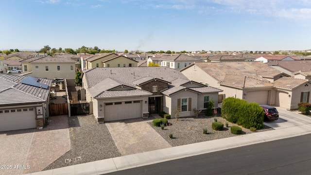 traditional-style house with a tiled roof, stucco siding, driveway, and a residential view