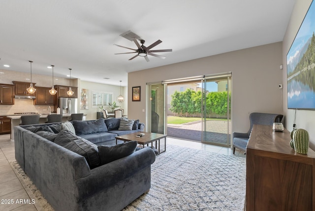 living room featuring light tile patterned flooring, a ceiling fan, recessed lighting, and a wealth of natural light
