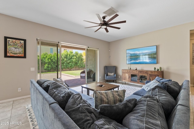 living area with a ceiling fan, baseboards, visible vents, and light tile patterned floors