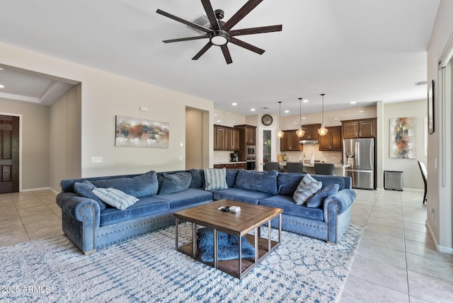 living room with baseboards, ceiling fan, recessed lighting, and light tile patterned flooring