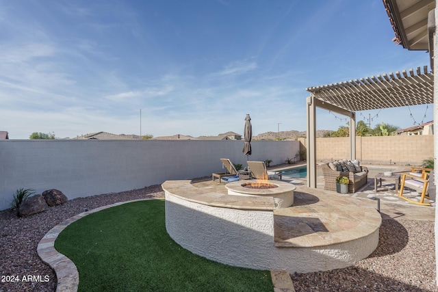 view of yard with a fire pit, a pergola, and a patio