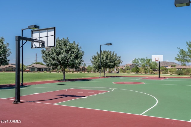 view of basketball court featuring a yard