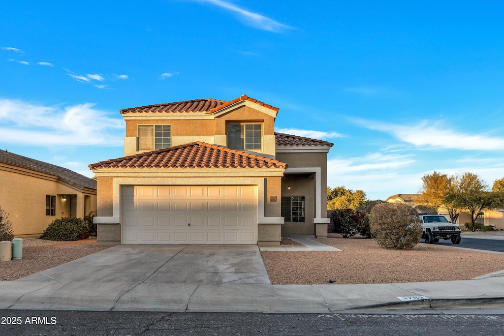 mediterranean / spanish home featuring a garage