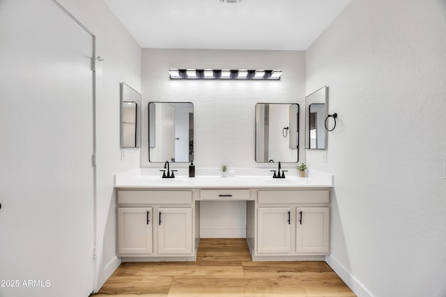 bathroom with wood-type flooring and vanity