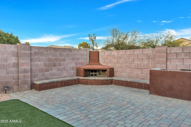 view of patio / terrace featuring an outdoor fireplace