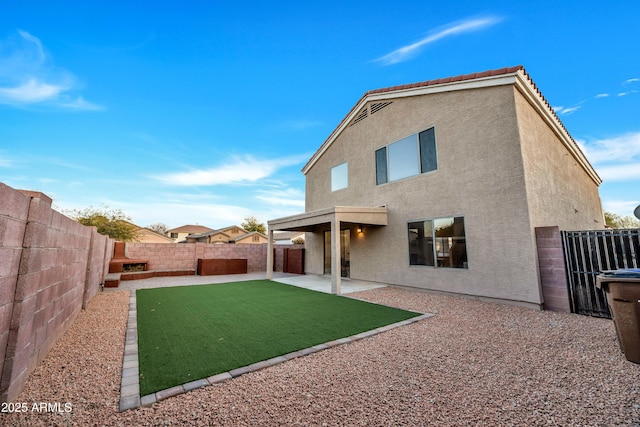 rear view of property featuring a patio area