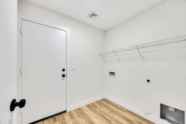 laundry room with hardwood / wood-style flooring, gas dryer hookup, electric dryer hookup, and washer hookup