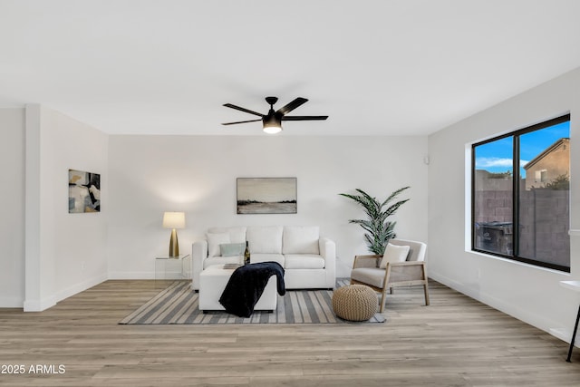 living room featuring ceiling fan and light wood-type flooring