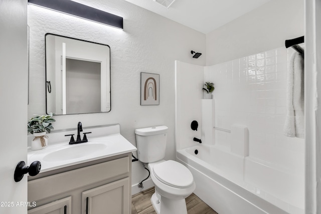 full bathroom featuring hardwood / wood-style flooring, vanity, shower / bathing tub combination, and toilet