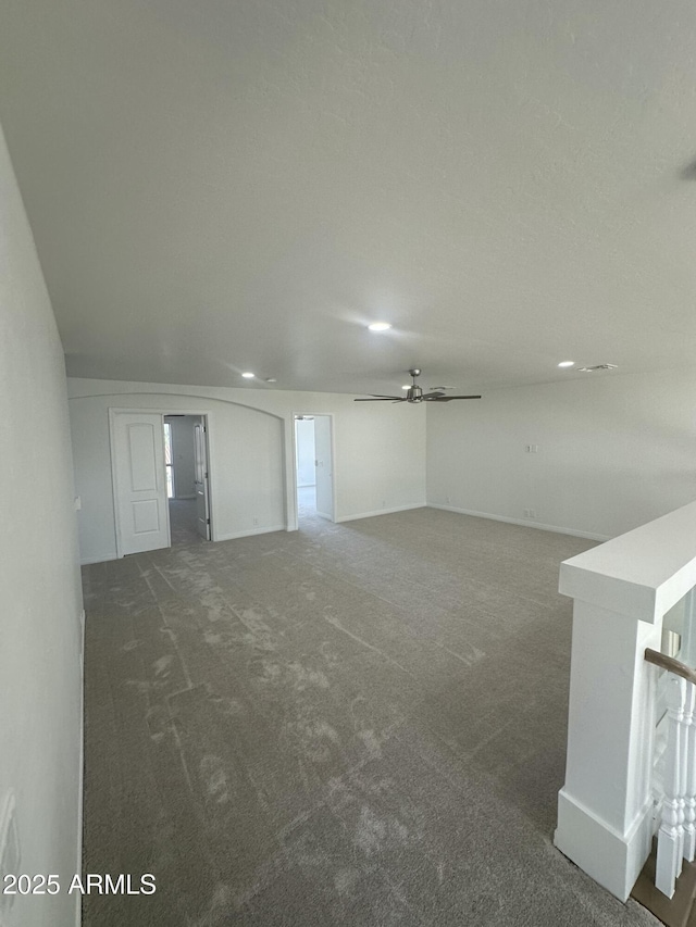 below grade area featuring baseboards, carpet, recessed lighting, and ceiling fan