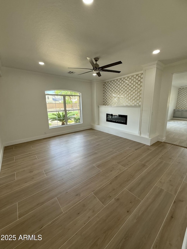 unfurnished living room featuring baseboards, wood finished floors, recessed lighting, and ceiling fan