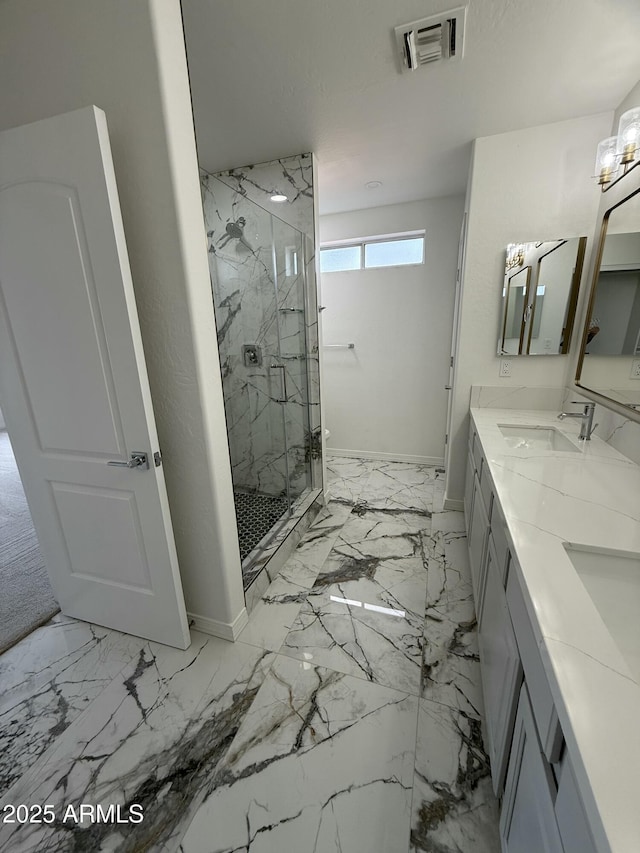 full bathroom with a marble finish shower, a sink, double vanity, baseboards, and visible vents