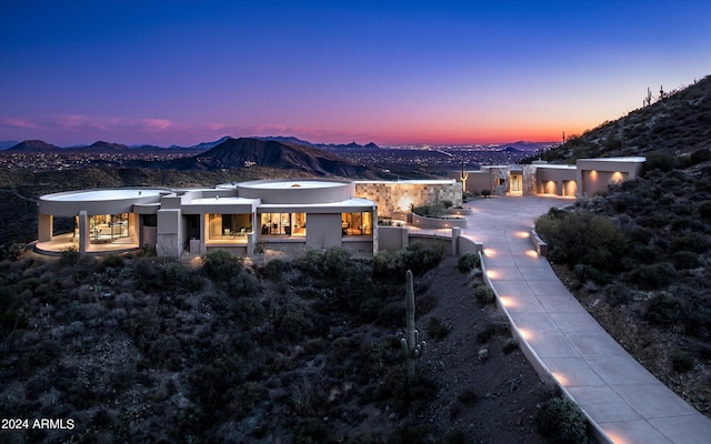 back house at dusk with a mountain view