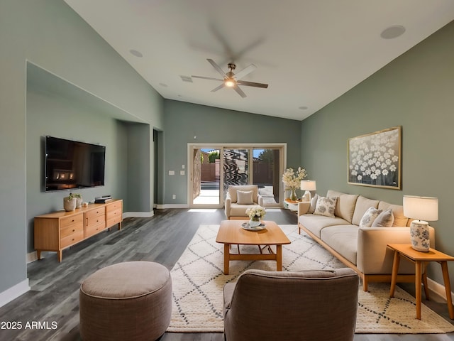 living room featuring lofted ceiling, ceiling fan, dark wood-type flooring, visible vents, and baseboards