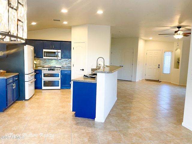 4968 E Meadow Vista Dr, Cornville, AZ 86325 - kitchen featuring visible vents, blue cabinetry, decorative backsplash, stainless steel appliances, and a ceiling fan