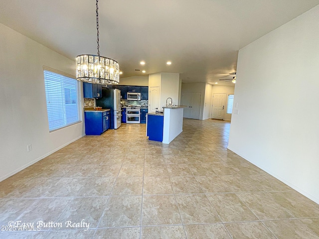 4968 E Meadow Vista Dr, Cornville, AZ 86325 - kitchen featuring backsplash, open floor plan, ceiling fan with notable chandelier, appliances with stainless steel finishes, and blue cabinets