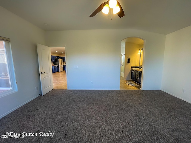 4968 E Meadow Vista Dr, Cornville, AZ 86325 - unfurnished room with light carpet, arched walkways, baseboards, and ceiling fan