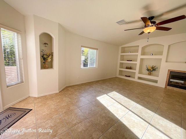 4968 E Meadow Vista Dr, Cornville, AZ 86325 - unfurnished living room featuring built in shelves, a ceiling fan, baseboards, light tile patterned flooring, and vaulted ceiling