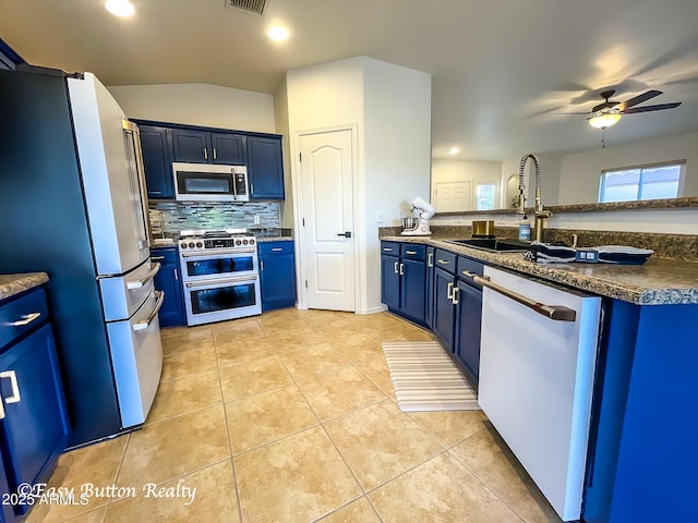 4968 E Meadow Vista Dr, Cornville, AZ 86325 - kitchen with light tile patterned floors, a ceiling fan, a sink, appliances with stainless steel finishes, and blue cabinets